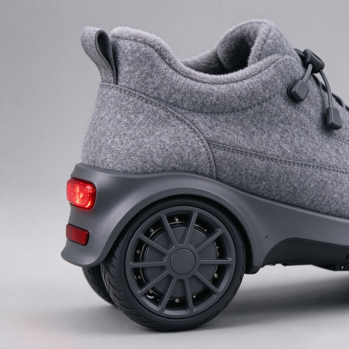 Side detail of the grey winter shoe showing the heel wheel and tread